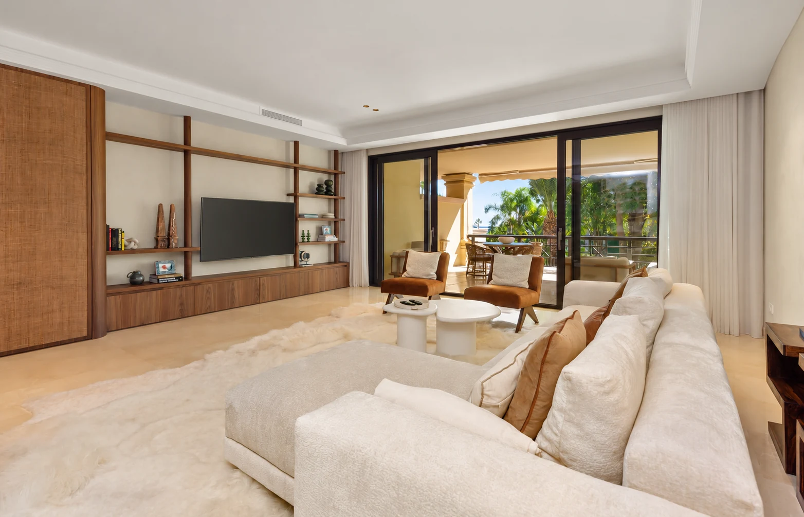 Living room looking out through the terrace towards green trees