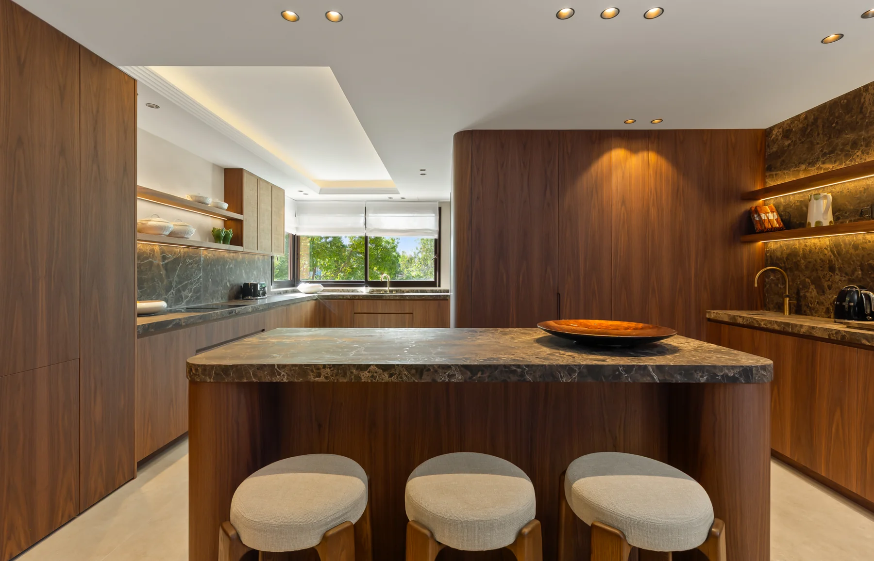 Kitchen with stone island and seating